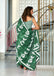 PETAL PARADISE FLORAL HAND PRINT MULMUL COTTON BOTTEL GREEN SAREE